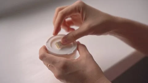 Returning used nicotine pouch to lid compartment after use Stock Footage 320896578