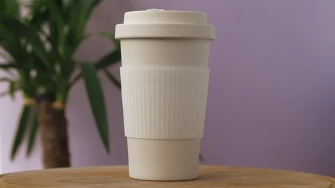 Reusable bamboo coffee cup rotating on the pink background Stock Footage 115367354