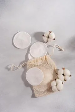 Reusable cotton pads with a drawstring pouch and cotton flowers, highlighting Stock Photos