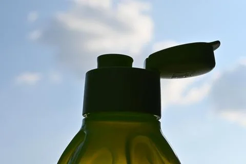 Reusable drinking bottle with open cap against sky Stock Photos