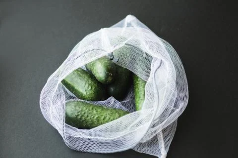 Reusable eco-friendly bag full of fresh seasonal cucumbers Stock Photos