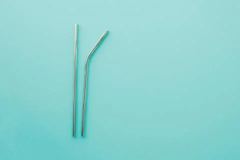Reusable eco friendly metallic straws on trendy mint background. Stock Photos
