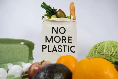 Reusable fabric shopping bag with text no more plastic, eco concept. Stock Photos