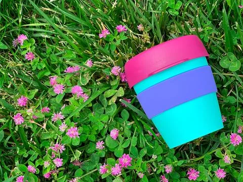 Reusable plastic beverage mug on the grass Stock Photos