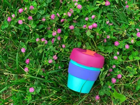 Reusable plastic beverage mug on the grass Stock Photos