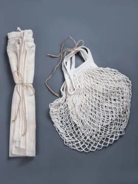 The reusable string bags for different products on the grey background. Stock Photos