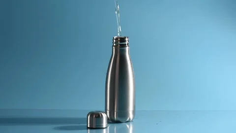Reusable water bottle. Zero Waste Lifestyle. Pouring water into bottle. Stock Footage