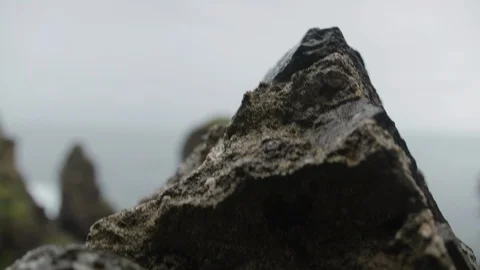 Reveal from behind rock to the cliffs and sea at Castle ruins Stock Footage 111529454