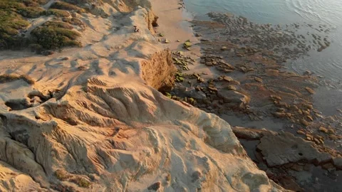 Reveal of cliffs, and people on the beach Video stock 221379552