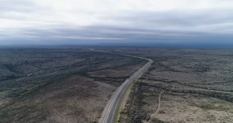Reveal of cyclist riding through flat enormous environment drone aerial 4K Stock Footage 111316535