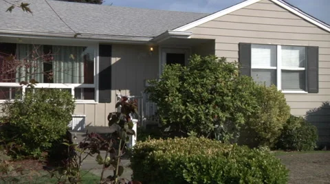 Reveal home through tree in front yard Stock Footage 49863079