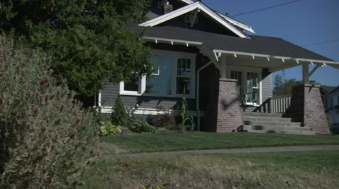 Reveal home through tree in front yard Stock Footage 49863108