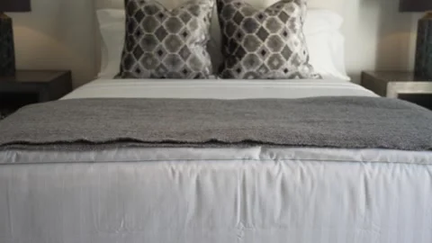 Reveal of a luxurious bed with two decorative pillows. Stock Footage 289486967