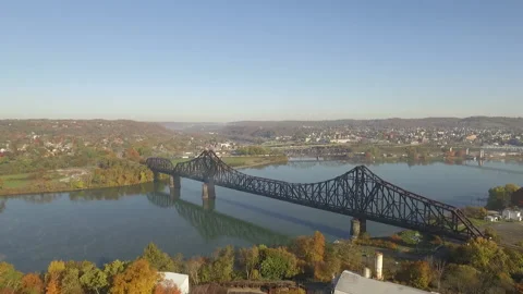 Reveal of old train bridge and city on a beautiful fall day Stock Footage 145095986