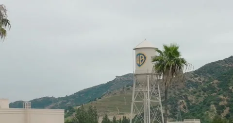 Reveal shot of Aerial pull-back shot of Warner Brothers WB Water Tower at Studio Stock-Footage 242862227