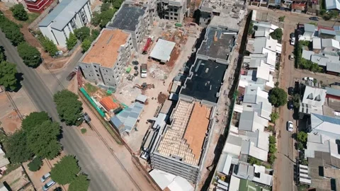 Reveal shot looking down over active construction site with cranes and Stock Footage 332608845