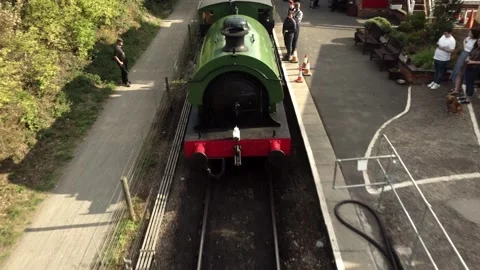 Reveal of a steam train at a platform 스톡 동영상 243778504
