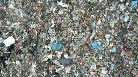 Revealing Aerial Of Plastic Garbage on the ground Stock Footage 147754153