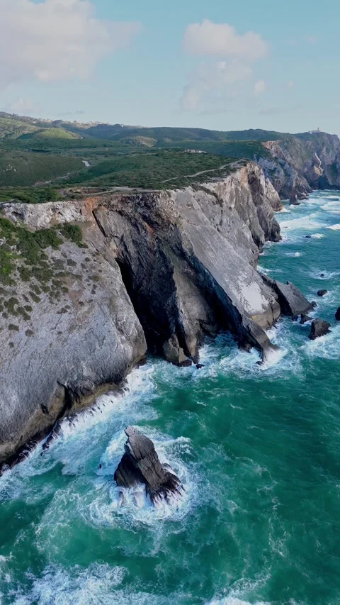 Revealing aerial shot of the rugged cliffs and turquoise Atlantic waters Stock Footage 320195680