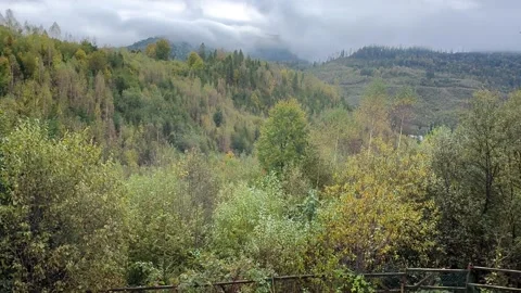 Revealing dramatic mountain landscape behind messy playground Stock-Footage 291741760