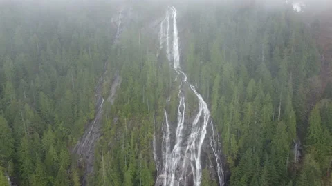 Revealing Massive Mountain Waterfall through a Dense, Foggy Forest Stock Footage 191798069