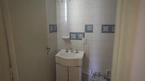 Revealing a ompact and simply designed tiled comfort room in slow motion Stock Footage 310214595