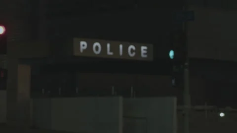 Revealing police station with focus pull rack. Cinematic shot at night Stock Footage 219318725