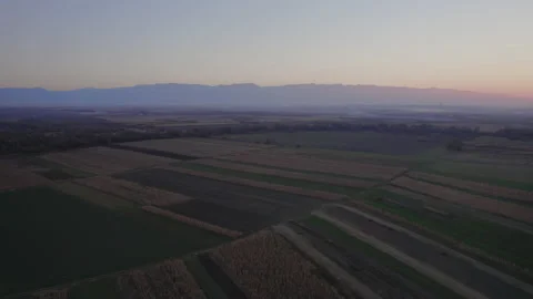 Revealing shot of sun setting down behind mountains in Transylvania 4k Stock Footage 165686272