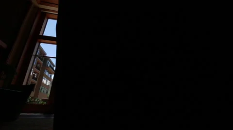 Reveals mountains through large window in hotel lobby Stock Footage 40734915