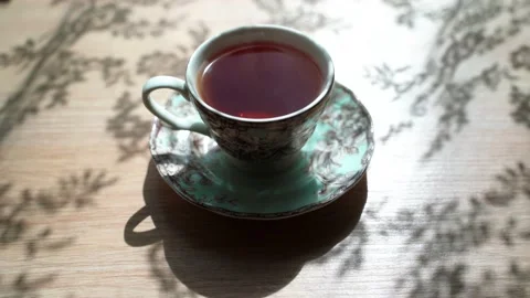 The revers effect. The tea bag is put in a cup. And the tea comes from black to Video stock 133998963