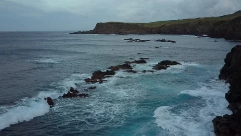 Reverse Aerial Of Big Waves Rolling Onto Quatro Ribeiras Rocks Natural Swimming Stock Footage 90689521