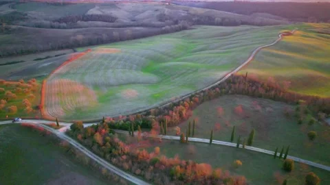 Reverse Aerial drone view at sunset Tuscany Italy Crete Senesi landscape Stock Footage 168584382