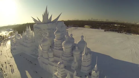 REVERSE AERIAL FLY OVER OF GIANT SNOW AND ICE SCULPTURE IN HARBIN CHINA Stock Footage 62759394
