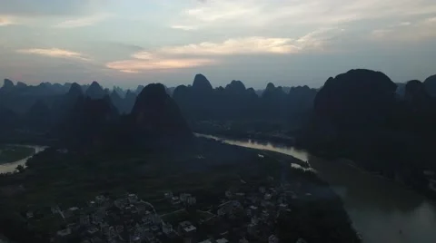 REVERSE AERIAL FLYOVER OF TOURISTS ON MOUNTAIN PEAK Stock Footage 65402842