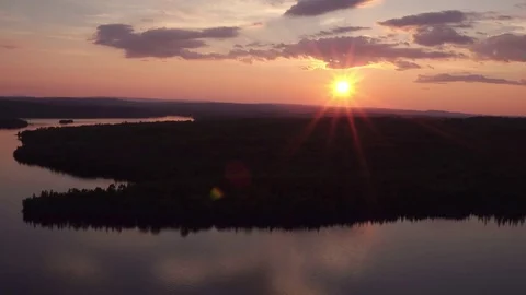 Reverse Aerial of Gorgeous purple sky sun set northern ontario canada Stock Footage 79196136