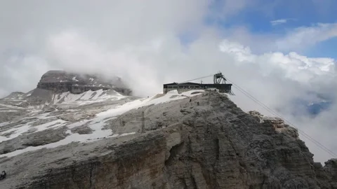 Reverse Aerial Of Piz Boe Mountain Summit Cross and Cable Car, Dolomites Italy Stock Footage 144424924