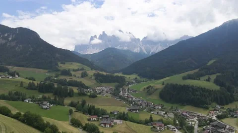 Reverse Aerial of Quaint Town of St. Magdalena with Alps Backdrop, Dolomites Stock Footage 144041166