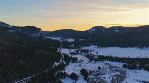 Reverse Aerial Tracking Shot of a Remote Snowy Mountain Pass at Wolf Creek Stock Footage 330900653