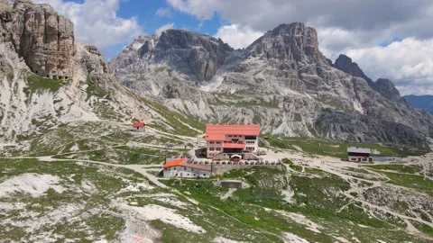 Reverse Aerial of Tre Cime Di Lavaredo Refuge Dreizinnenhütte, Dolimites Alps Stock Footage 144642428