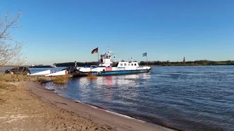 Reverse aerial view of ferry unloading cars on shore Stock Footage 341298023