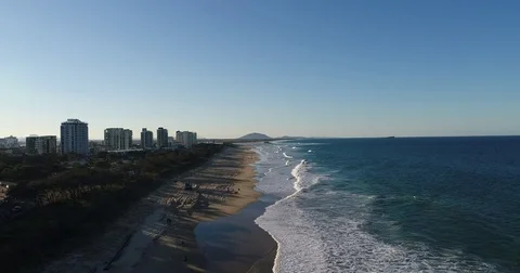 Reverse aerial of waves and beach with tree shadows Vídeo Stock 79776170
