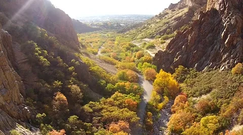 Reverse up canyon rotate left to rock climber Video stock 43555917