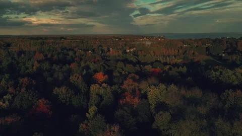 Reverse Descending Drone Flight High Above The Trees Glowing Clouds Video stock 255048908
