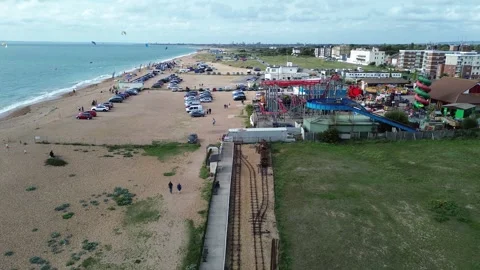 Reverse drone shot from Funland Amusement Park, Hayling Island along railway Stock Footage 254021905