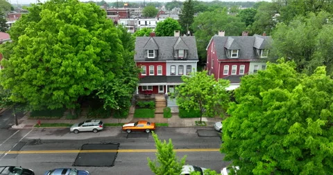 Reverse drone shot of house in city. Single family home in town on rainy Stock Footage 194645083