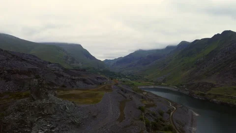Reverse drone shot of  Llanberis Quarry and llyn, lake Stock Footage 232771757