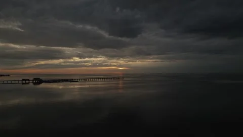 Reverse drone view of dusk setting over Mobile Bay Alabama Stock Footage 296808188
