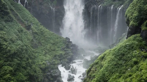 Reverse Effect Waterfall move up with Green Moss Covered Rock Stock Footage 129303028