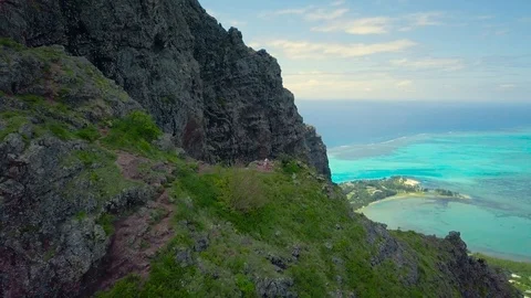 Reverse flight above the peak of Le Morne Brabant mountain Stock Footage 102402303