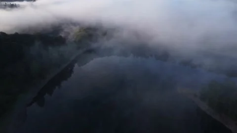 Reverse flight over misty landscape 스톡 동영상 203651352